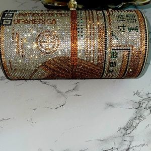 Clutch bag with shiny golden dollar note design.